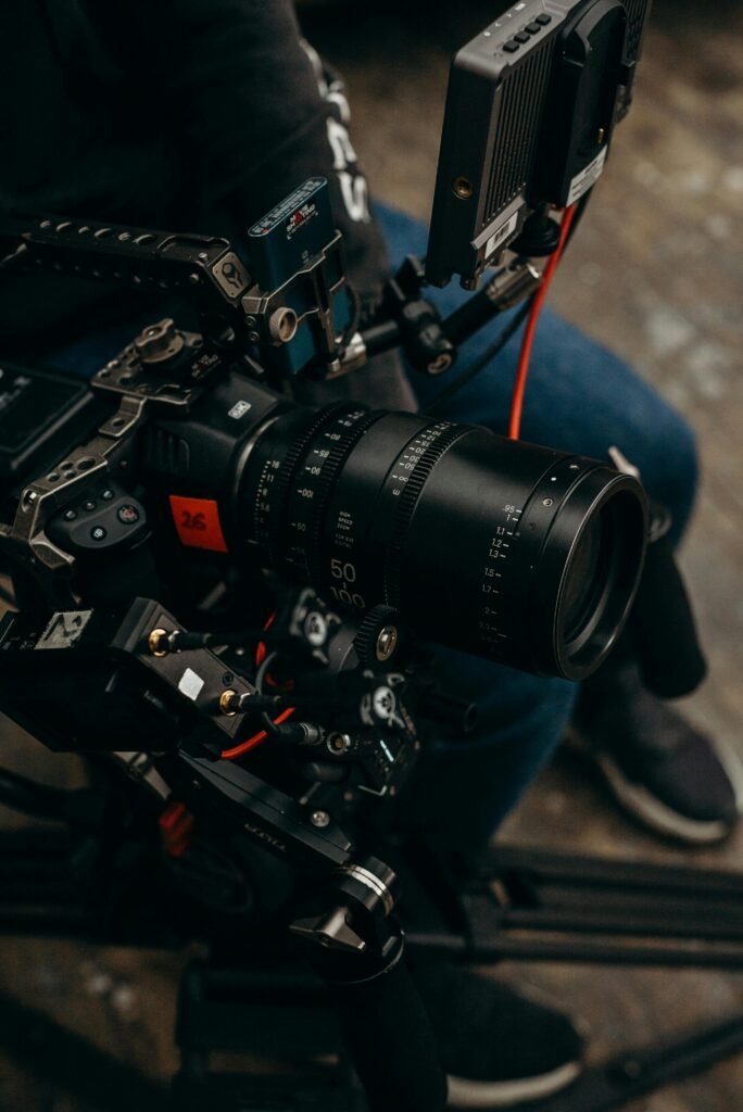 Close-up of a modern video camera rig with a detailed lens and accessories.